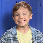 A young boy smiling for the camera.